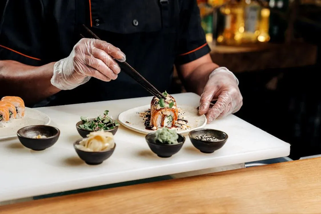 Chef plating gourmet sushi roll at EGAWA, a Japanese Restaurant in Malvern